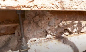 Anchor bolts installed in concrete foundation to meet building code requirements