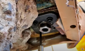 Tie-down strap anchor failing on wood framing due to corrosion and stress