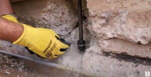 Anchor bolts fastening wall framing to a concrete foundation during construction